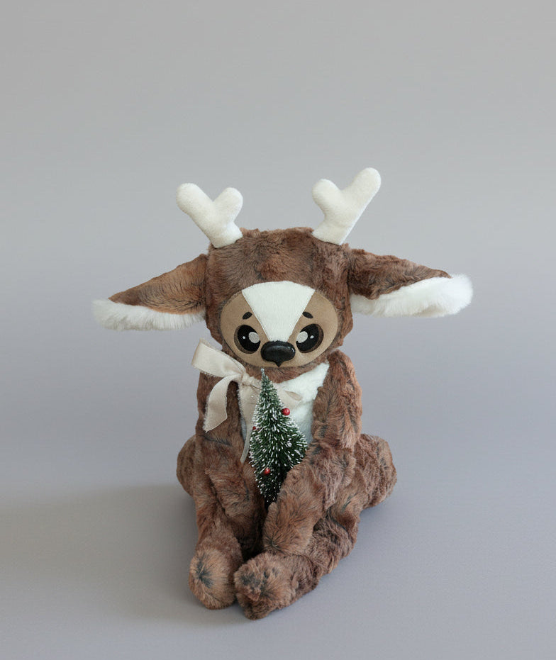 Plush reindeer toy with a small Christmas tree 