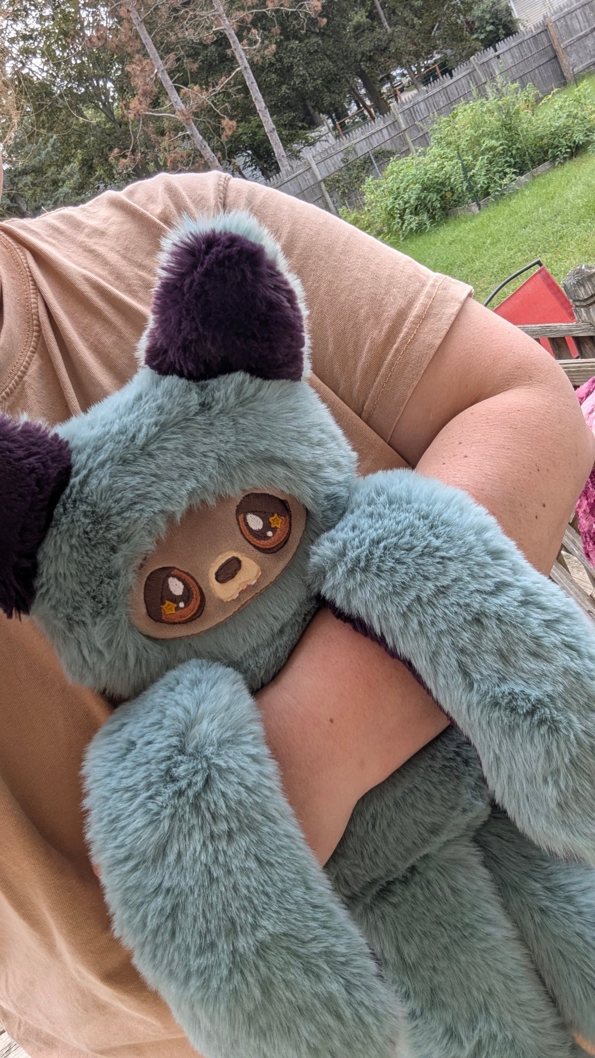 Evvies Lovies Jasper Noodle Wolf Pup plush with teal fluffy fur, plum purple ears, and amber eyes with star accents.