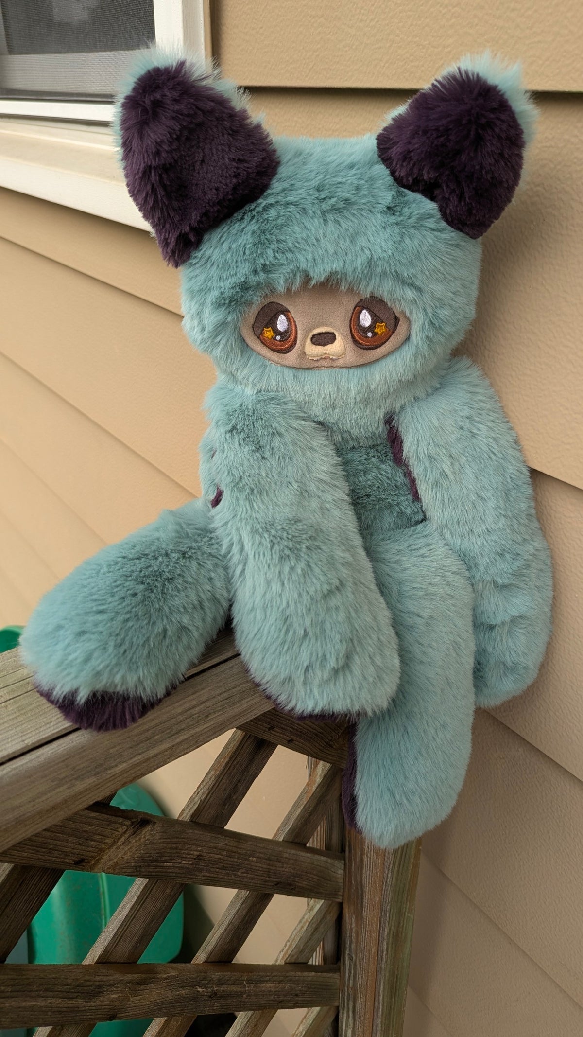 Evvies Lovies Jasper Noodle Wolf Pup plush with teal and plum fluffy fur, amber star eyes, and taupe mochi minky face.