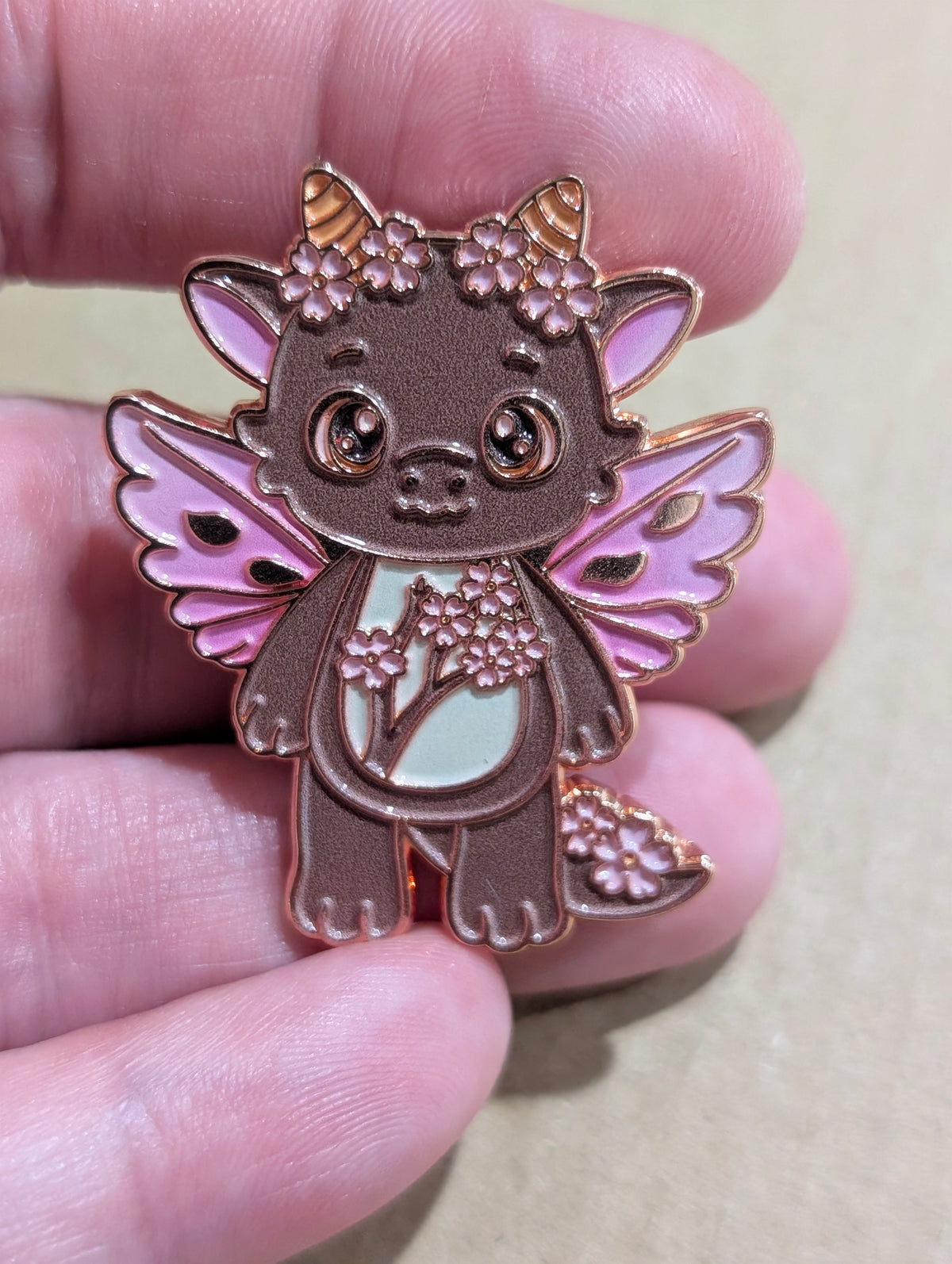 Cherry Blossom Dragon limited edition enamel pin with pink wings and blossoms on rose gold